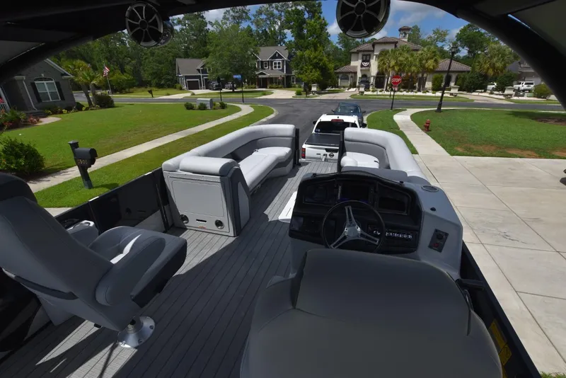 Slide: The Image of 2023 Bentley Pontoons 250 Elite Swingback Dual Captain on a residential street. - 14