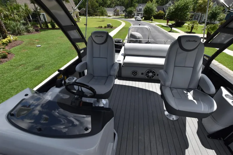 Slide: The Image of 2023 Bentley Pontoons 250 Elite Swingback Dual Captain interior with luxurious seating and helm. - 6