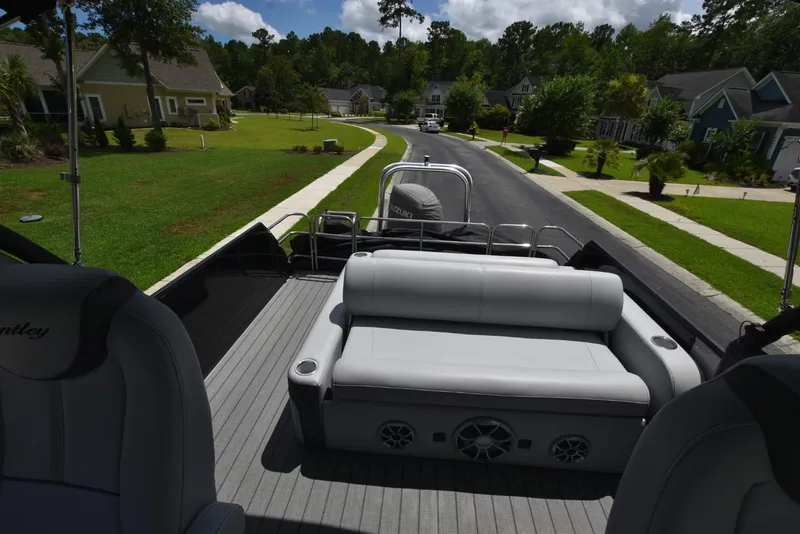 Slide: The Image of 2023 Bentley Pontoons 250 Elite Swingback Dual Captain on a residential street. - 7