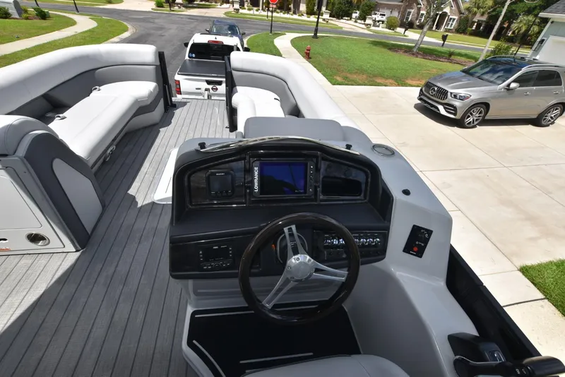 Slide: The Image of 2023 Bentley Pontoons 250 Elite Swingback Dual Captain interior with modern dashboard and seating. - 8