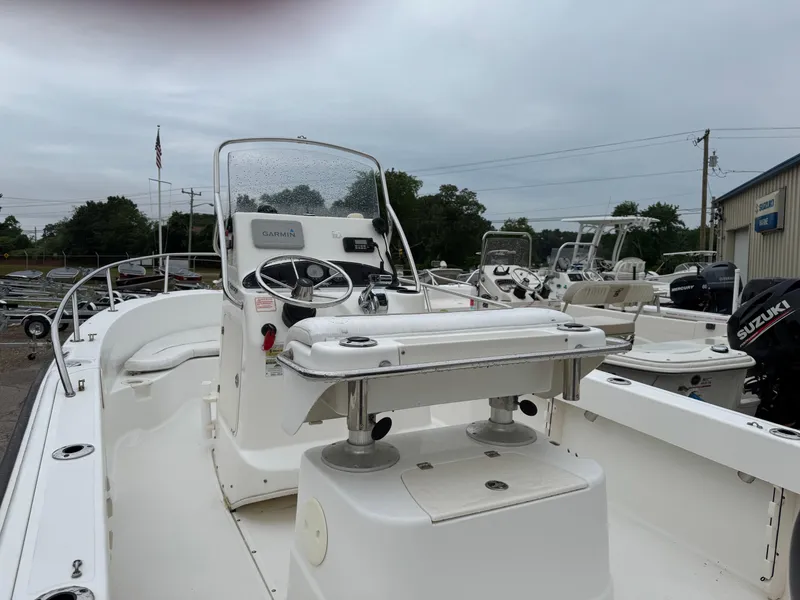 Slide: The Image of 2006 Boston Whaler 190 Outrage boat with Garmin navigation, docked outdoors. - 13