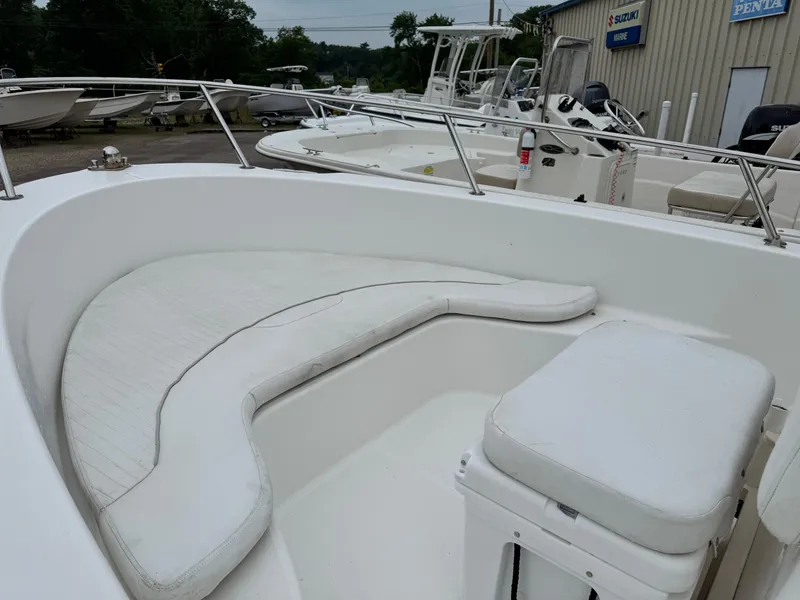 Slide: The Image of 2006 Boston Whaler 190 Outrage boat interior with white seating and railing. - 14