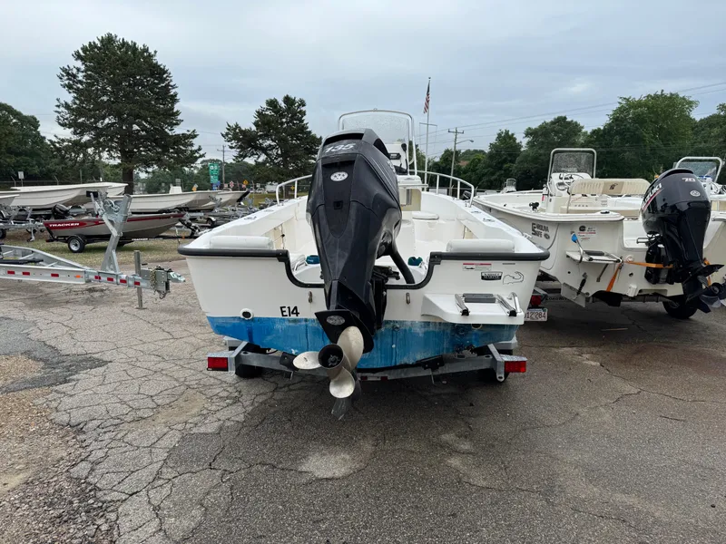 Slide: The Image of 2006 Boston Whaler 190 Outrage boat on trailer, rear view, parked outdoors. - 6