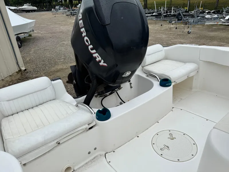 Slide: The Image of 2006 Boston Whaler 190 Outrage boat interior with Mercury engine and white seating. - 9