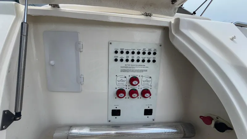 Slide: The Image of Control panel of a 2007 Chaparral Signature 330 boat, featuring switches and dials. - 12