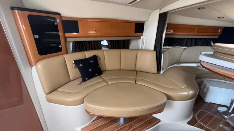 Slide: The Image of 2007 Chaparral Signature 330 interior with tan leather seating and wooden accents. - 20