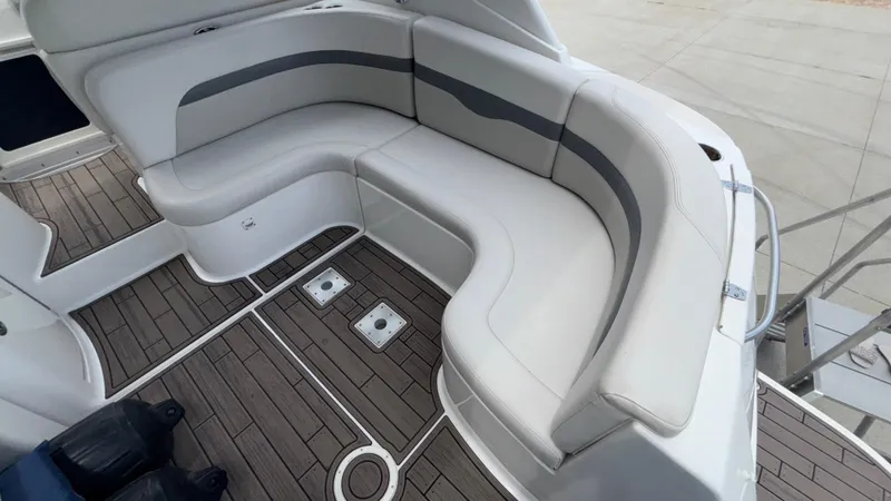 Slide: The Image of 2007 Chaparral Signature 330 boat interior with curved seating and wood-patterned flooring. - 21