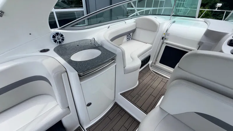 Slide: The Image of 2007 Chaparral Signature 330 interior with sleek seating, sink, and modern design. - 25