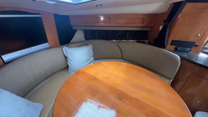 Slide: The Image of 2007 Chaparral Signature 330 interior with round table and cushioned seating. - 29