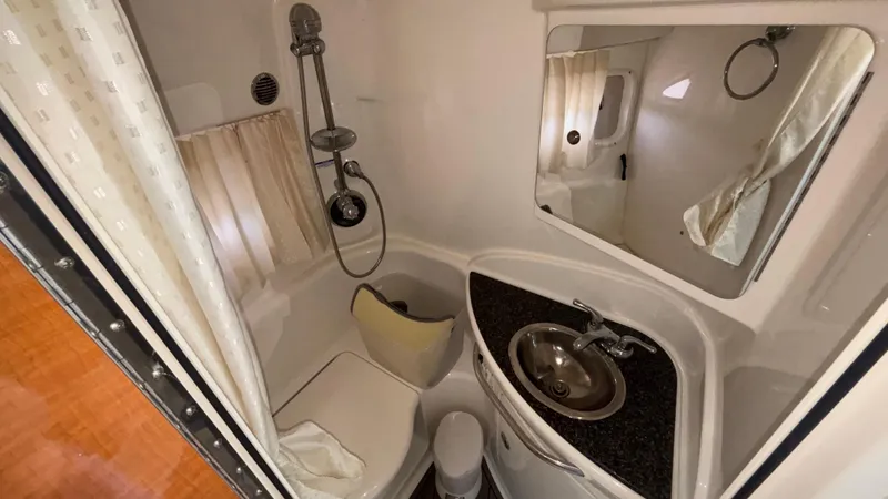 Slide: The Image of Bathroom interior of 2007 Chaparral Signature 330 yacht with sink, shower, and mirror. - 34