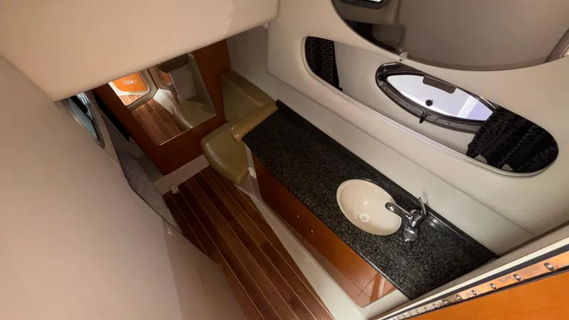 Slide: The Image of 2007 Chaparral Signature 330 yacht interior with sink, mirror, and wooden flooring. - 38