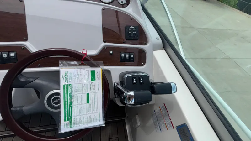 Slide: The Image of Steering wheel and controls of 2007 Chaparral Signature 330 boat cockpit. - 44