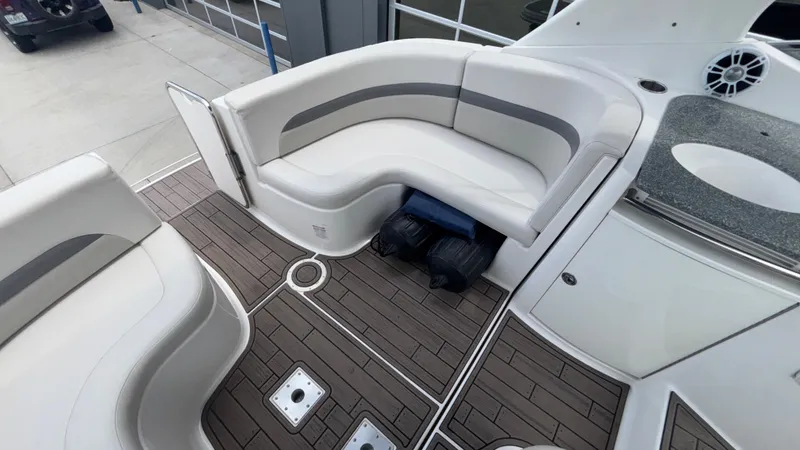 Slide: The Image of 2007 Chaparral Signature 330 boat interior with white seating and wood-patterned flooring. - 9