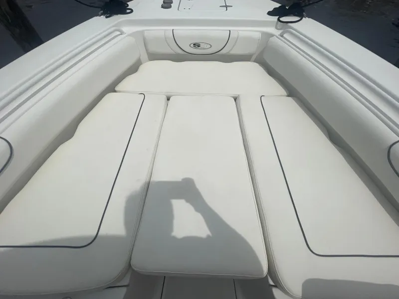 Slide: The Image of 2016 Sea Hunt Gamefish 27 boat interior with white cushioned seating. - 11