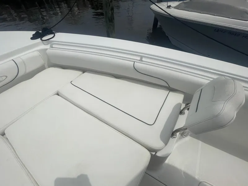 Slide: The Image of 2016 Sea Hunt Gamefish 27 boat interior with white cushioned seating. - 13