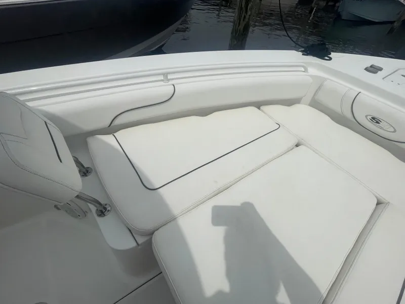 Slide: The Image of 2016 Sea Hunt Gamefish 27 boat interior with white cushioned seating. - 14