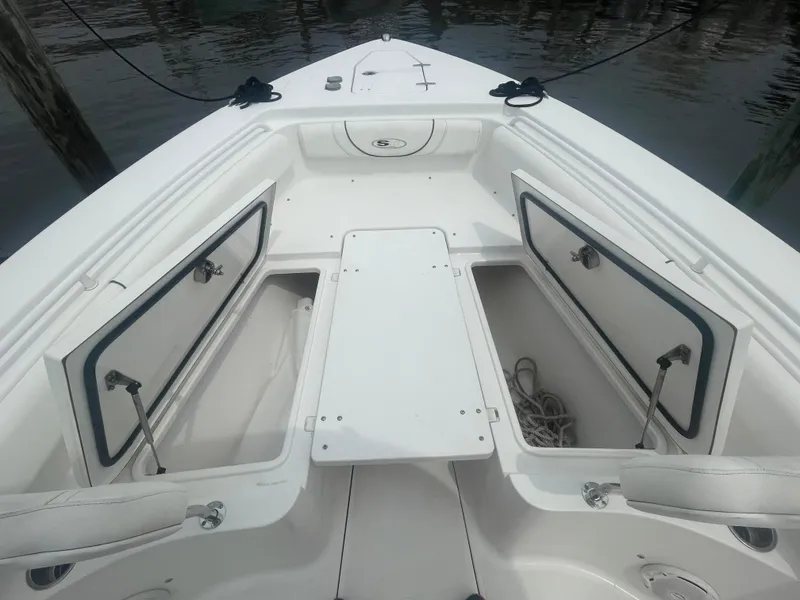 Slide: The Image of 2016 Sea Hunt Gamefish 27 boat with open storage compartments on deck. - 15