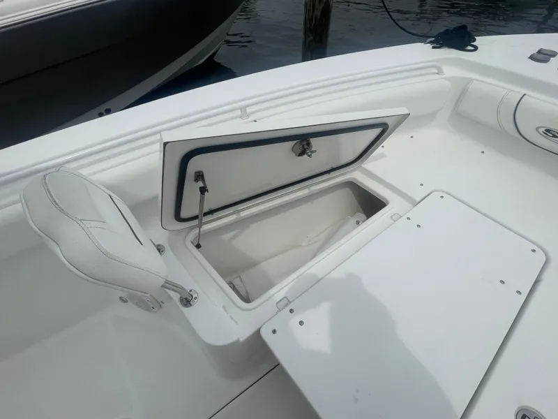 Slide: The Image of 2016 Sea Hunt Gamefish 27 boat with open storage compartment and seating. - 17