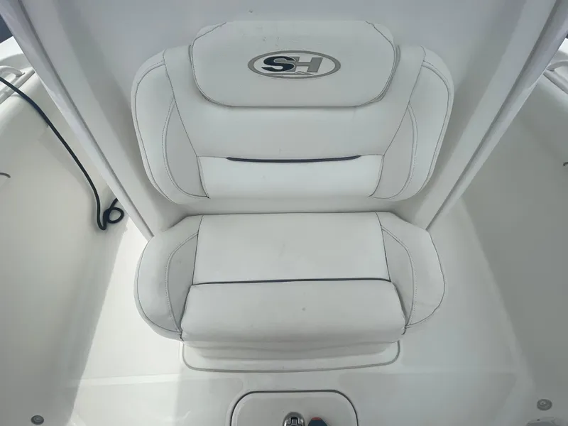 Slide: The Image of White seating on a 2016 Sea Hunt Gamefish 27 boat, featuring the SH logo. - 19