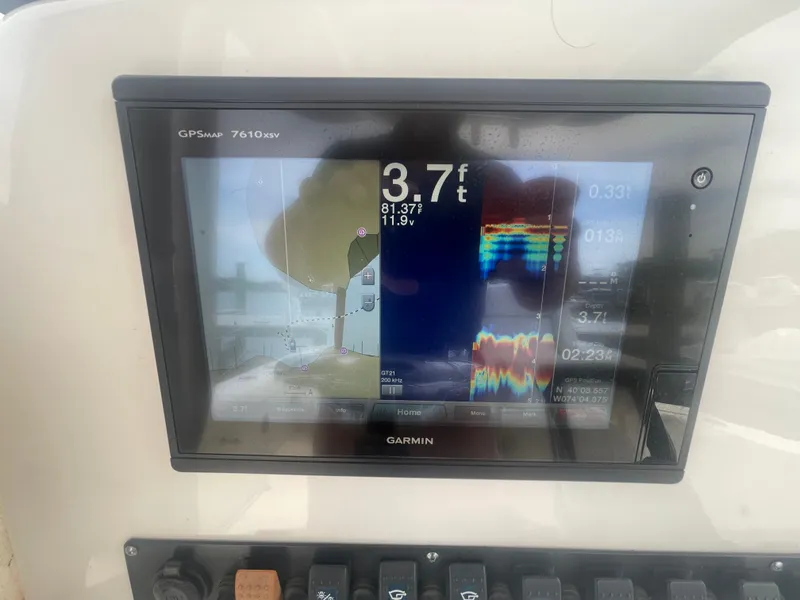 Slide: The Image of Garmin GPS display on 2016 Sea Hunt Gamefish 27 showing depth and navigation data. - 23