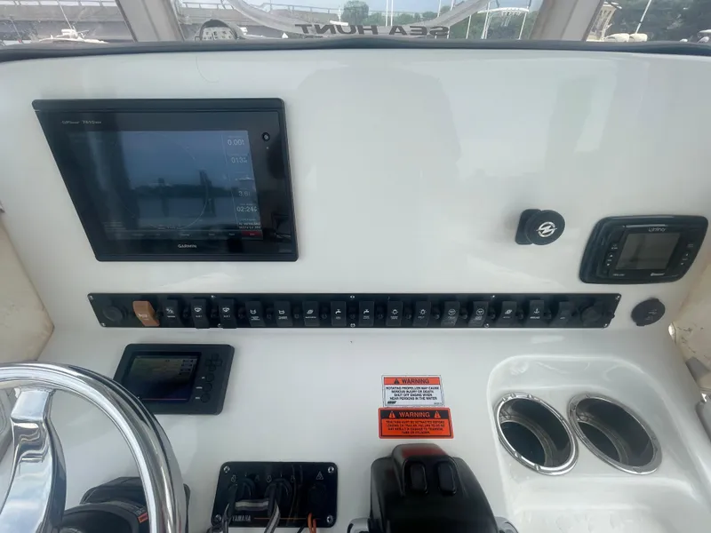 Slide: The Image of 2016 Sea Hunt Gamefish 27 dashboard with Garmin display and control panel. - 29