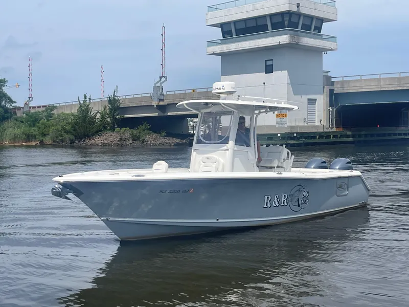 Slide: The Image of 2016 Sea Hunt Gamefish 27 boat on water with Yamaha engine, clear sky background. - 3
