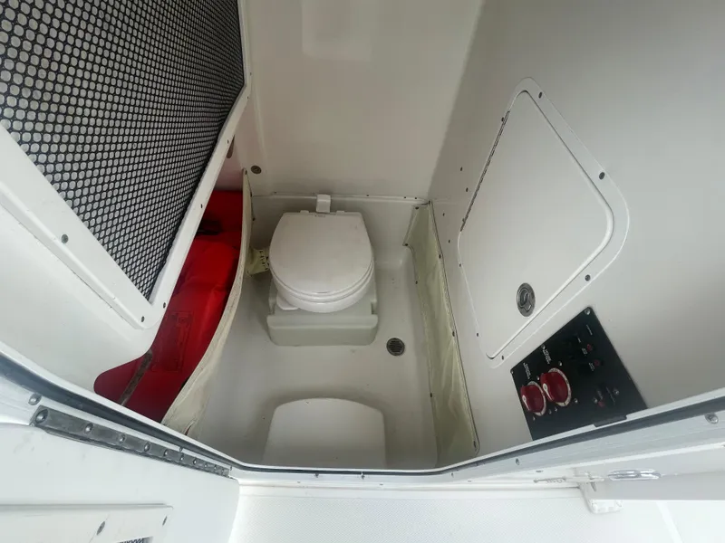 Slide: The Image of Interior of 2016 Sea Hunt Gamefish 27 boat with toilet and control panel. - 34
