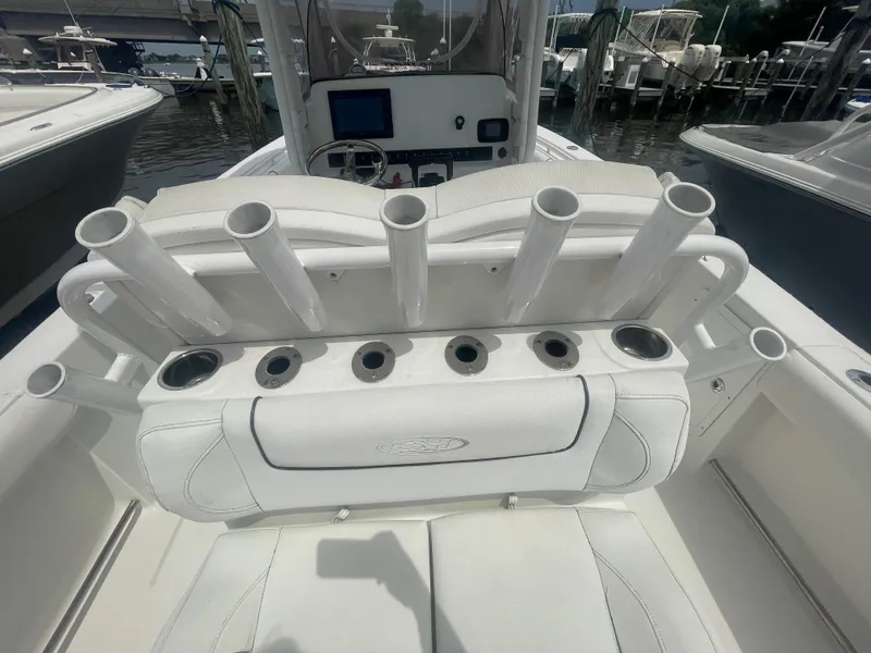 Slide: The Image of 2016 Sea Hunt Gamefish 27 boat interior with rod holders and seating. - 39
