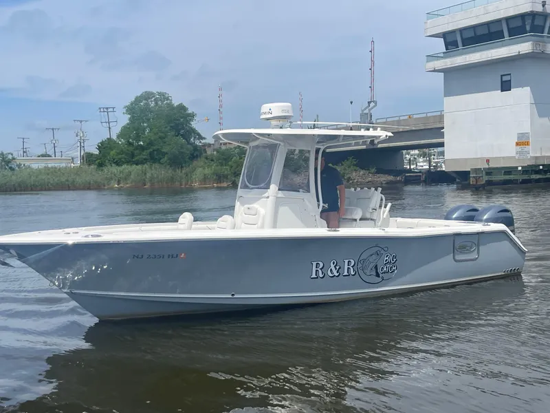 Slide: The Image of 2016 Sea Hunt Gamefish 27 boat on water near a bridge and control tower. - 4