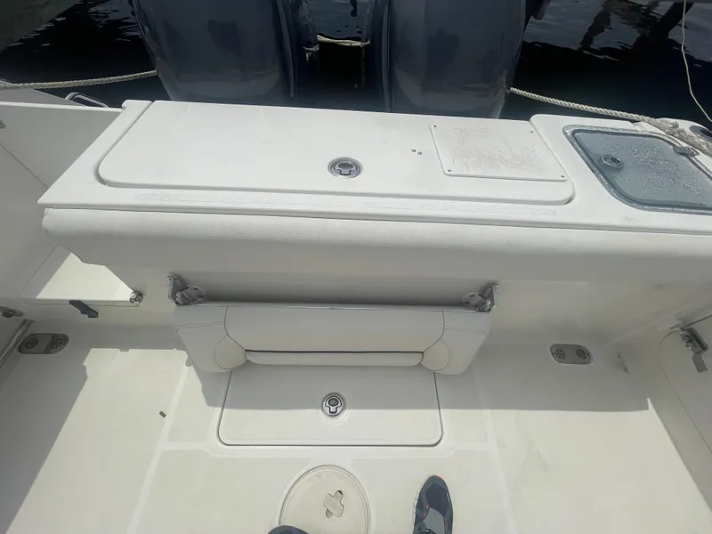 Slide: The Image of 2016 Sea Hunt Gamefish 27 boat deck with storage compartments and dual engines. - 43