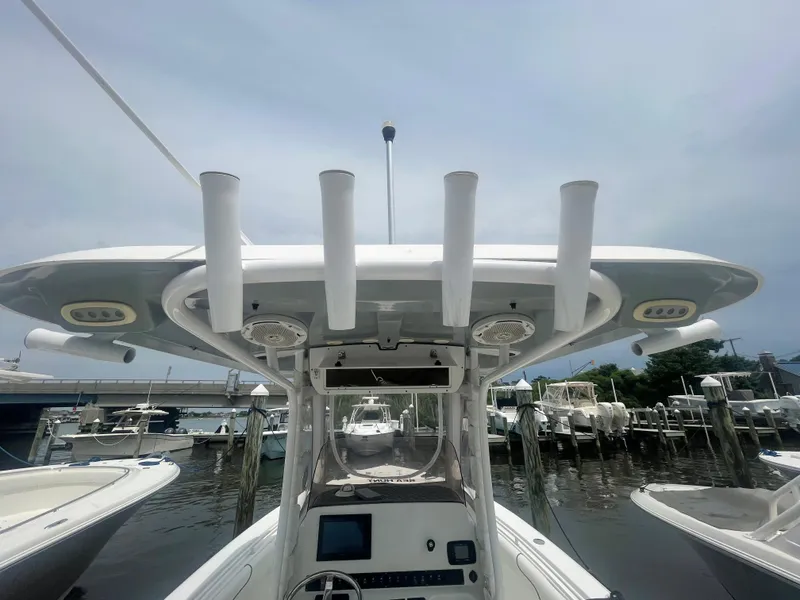 Slide: The Image of 2016 Sea Hunt Gamefish 27 boat with T-top and rod holders at marina. - 45