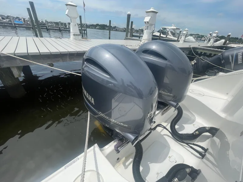 Slide: The Image of Twin Yamaha outboard motors on a 2016 Sea Hunt Gamefish 27 at a marina dock. - 47