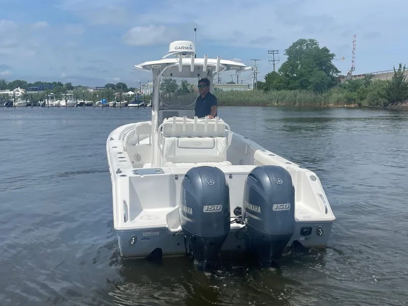 Slide: The Image of 2016 Sea Hunt Gamefish 27 boat with dual Yamaha engines on the water. - 8