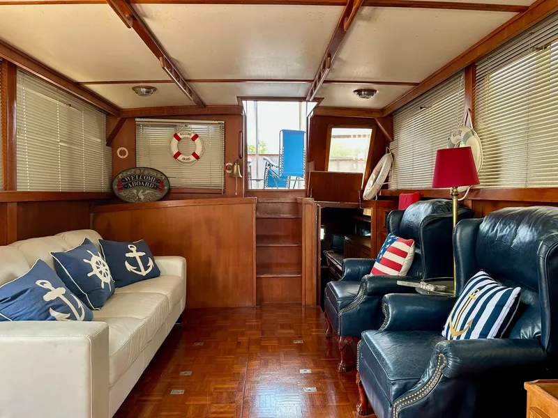 Slide: The Image of Interior of 1987 Jefferson Sundeck yacht with nautical-themed decor and comfortable seating. - 16