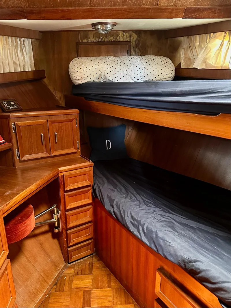 Slide: The Image of 1987 Jefferson Sundeck interior with wooden bunk beds and storage cabinets. - 18