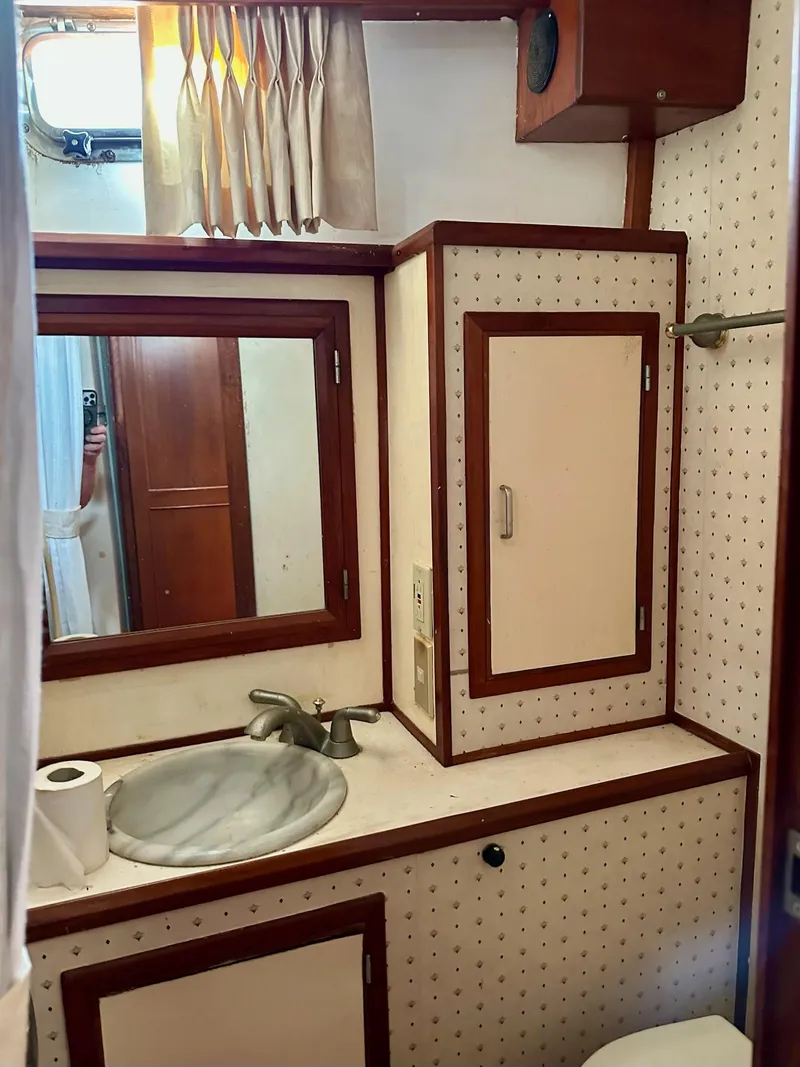 Slide: The Image of 1987 Jefferson Sundeck bathroom with sink, mirror, and storage cabinet. - 19