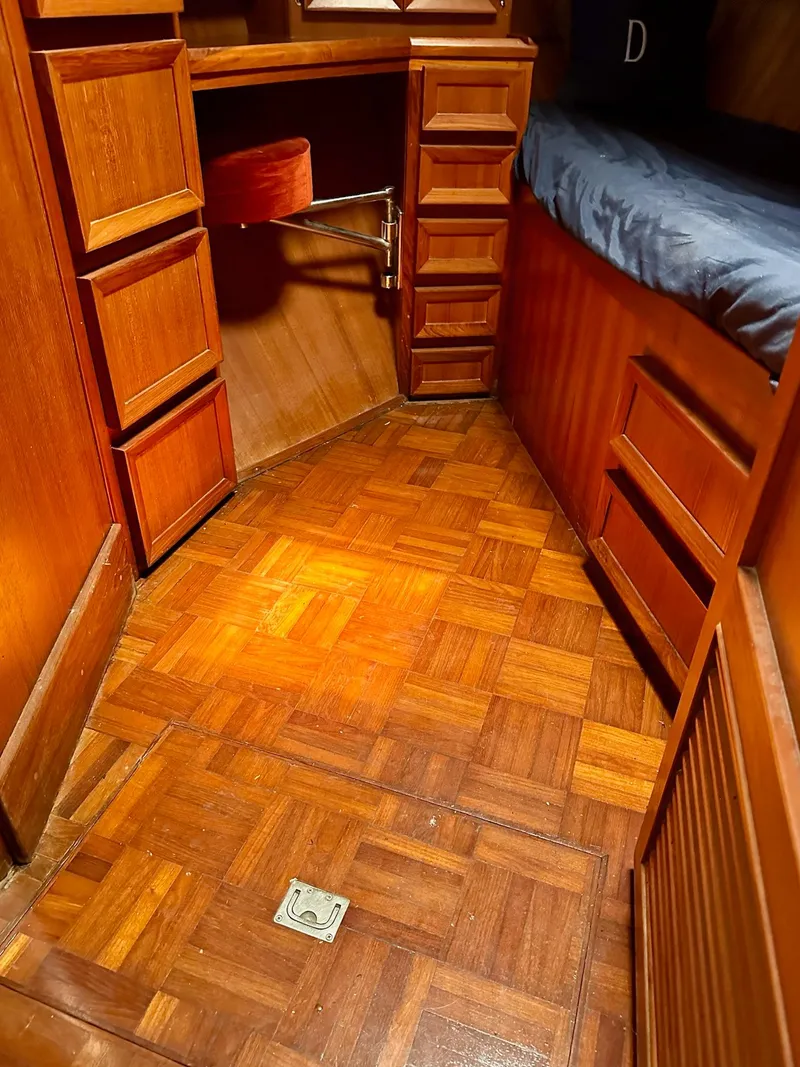 Slide: The Image of 1987 Jefferson Sundeck interior with wooden flooring, built-in drawers, and a cozy bed. - 21