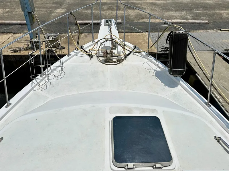 Slide: The Image of 1987 Jefferson Sundeck boat deck with railing and equipment at dock. - 3