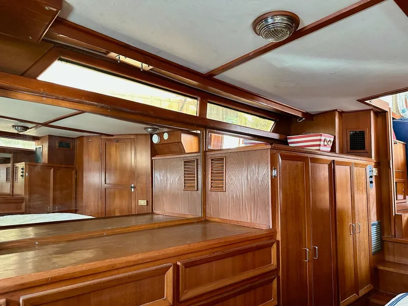 Slide: The Image of Interior of 1987 Jefferson Sundeck yacht with wooden cabinetry and nautical decor. - 32