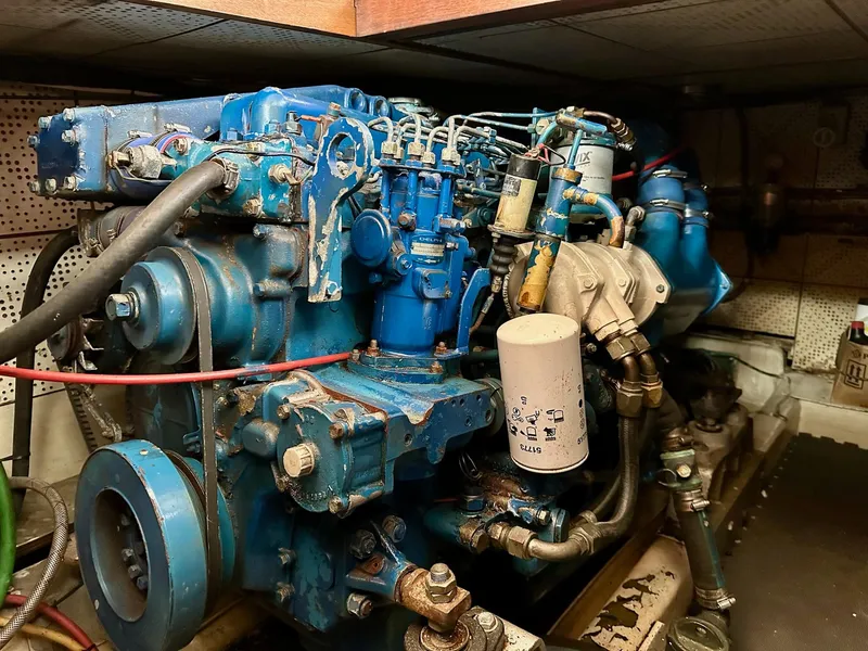 Slide: The Image of Engine of a 1987 Jefferson Sundeck boat, showcasing intricate mechanical components. - 38