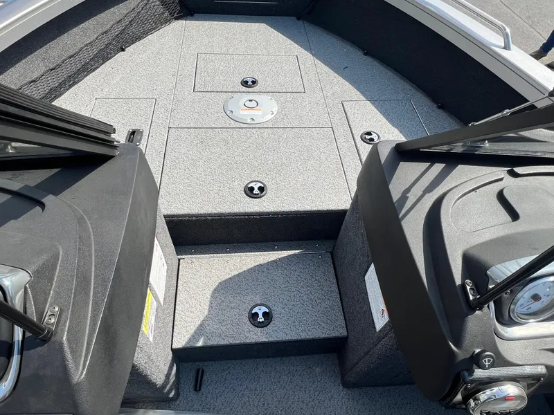 Slide: The Image of 2025 Crestliner 2050 Authority boat interior with gray flooring and storage compartments. - 15