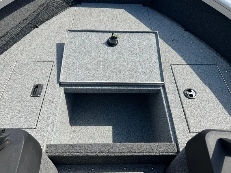 Slide: The Image of 2025 Crestliner 2050 Authority boat interior with storage compartments and textured flooring. - 16