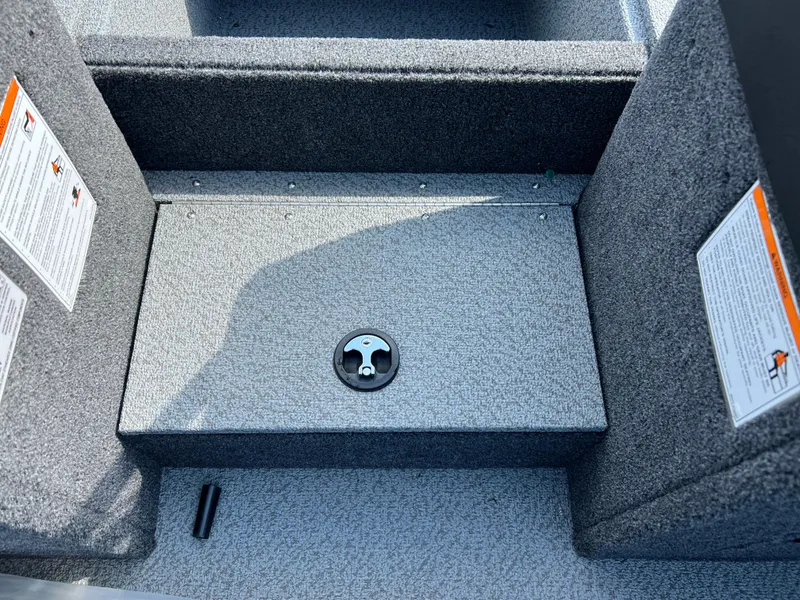 Slide: The Image of Interior of 2025 Crestliner 2050 Authority boat, featuring carpeted flooring and storage compartment. - 17