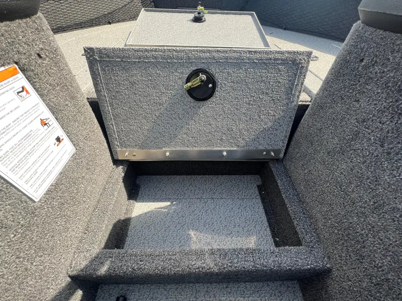Slide: The Image of 2025 Crestliner 2050 Authority boat interior with storage compartment and safety instructions. - 18