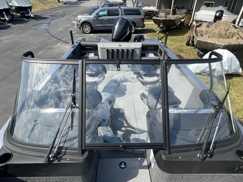 Slide: The Image of 2025 Crestliner 2050 Authority boat with windshield, parked outdoors. - 19