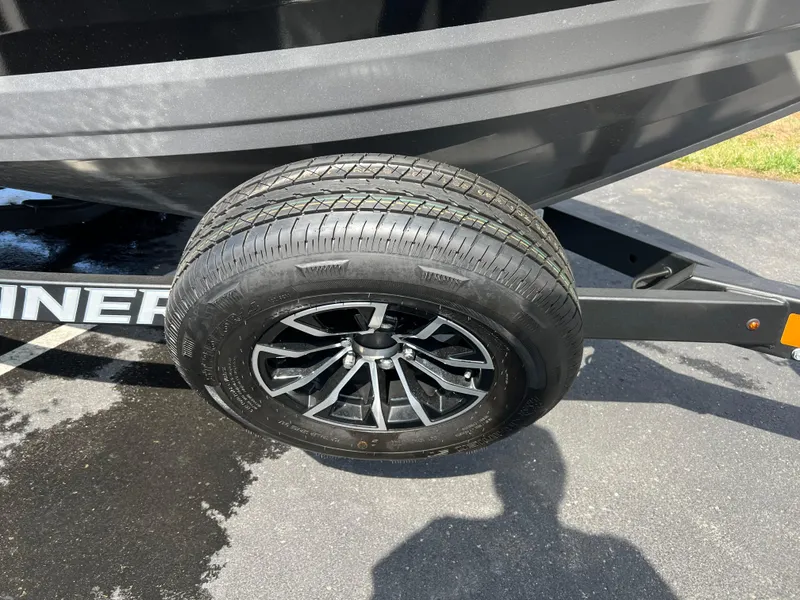 Slide: The Image of 2025 Crestliner 2050 Authority trailer wheel on asphalt, showcasing black alloy rim. - 4