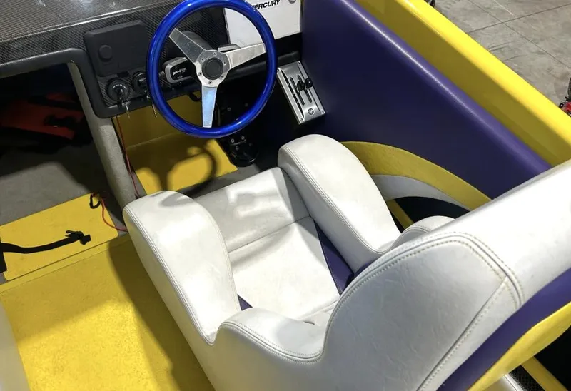Slide: The Image of Interior of a 2018 Predator C30 boat with blue steering wheel and white seat. - 11
