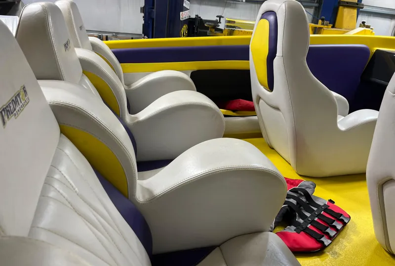 Slide: The Image of Interior of a 2018 Predator C30 boat with white and yellow seating. - 14