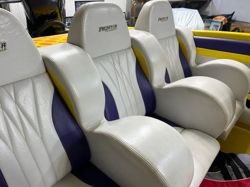 Slide: The Image of White and purple seats in a 2018 Predator C30 boat interior. - 15