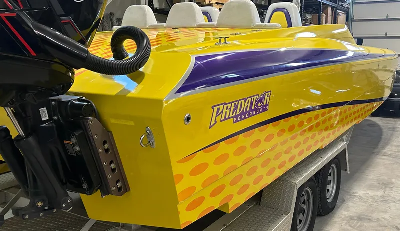 Slide: The Image of Yellow and purple 2018 Predator C30 powerboat on trailer in a garage. - 4